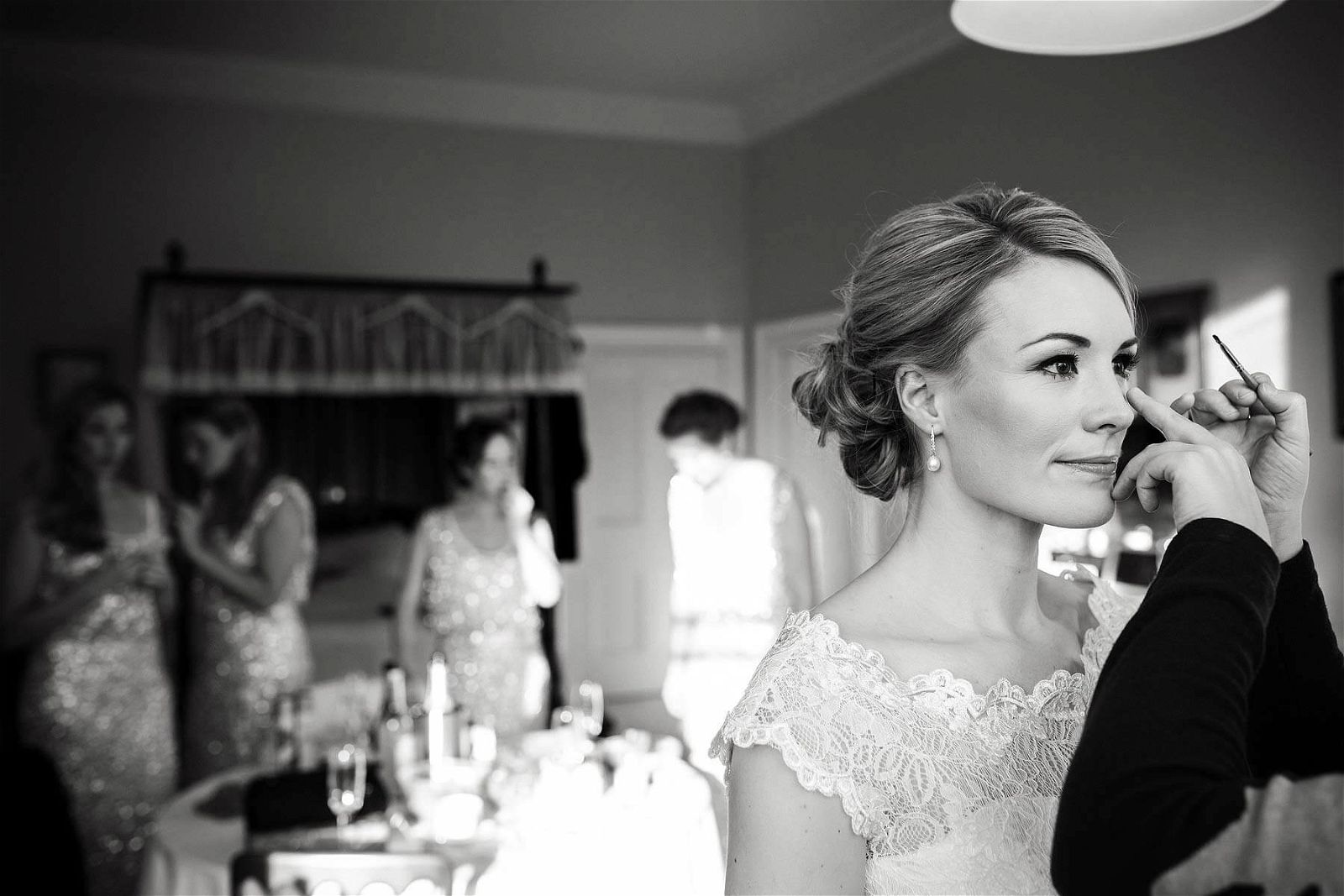 Documentary photograph of the Bride getting her makeup finished at Sandon Hall in Stafford by Documentary Wedding Photographer Stuart James