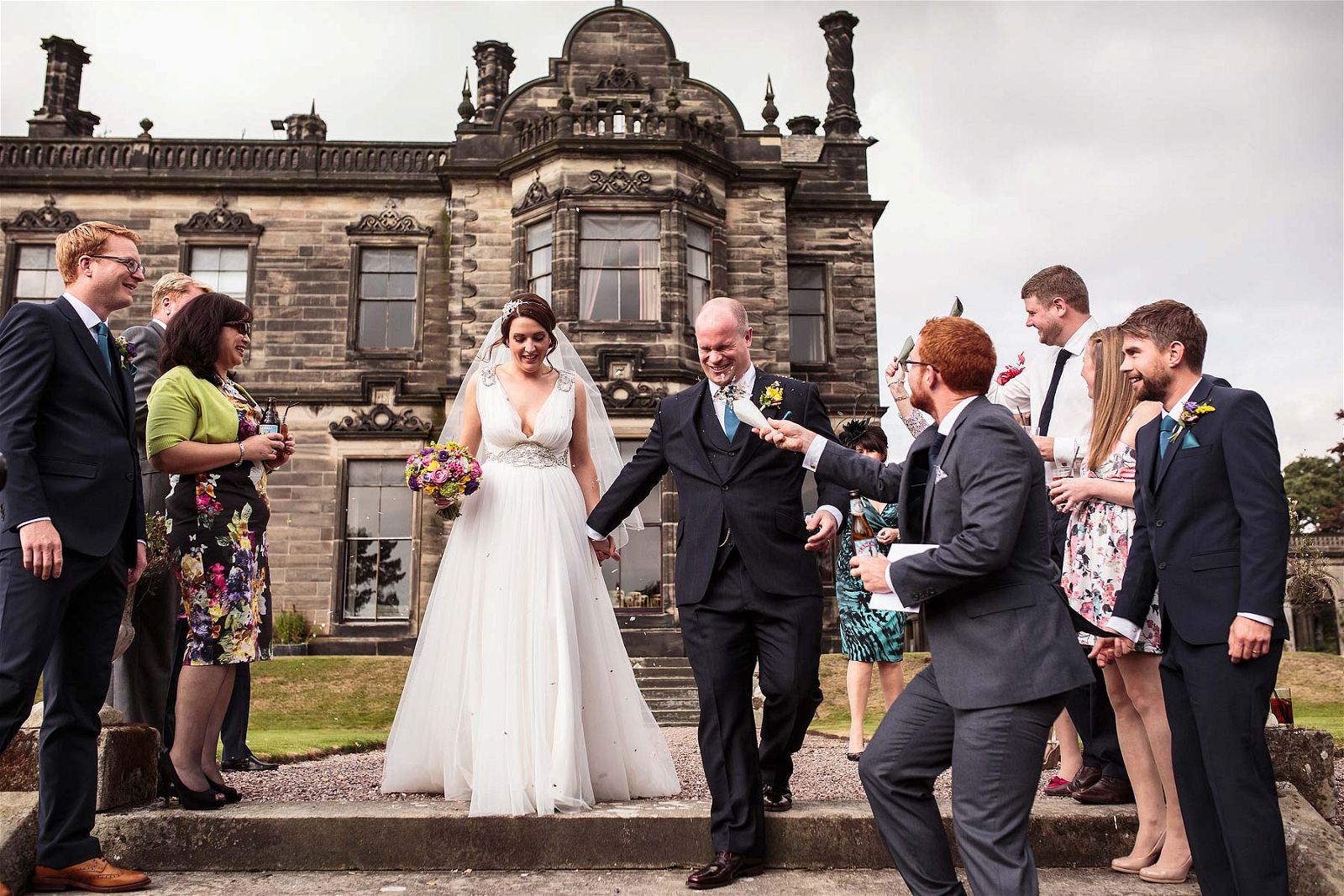 Confetti fun on the steps at Sandon Hall in Stafford by Stafford Reportage Wedding Photographer Stuart James