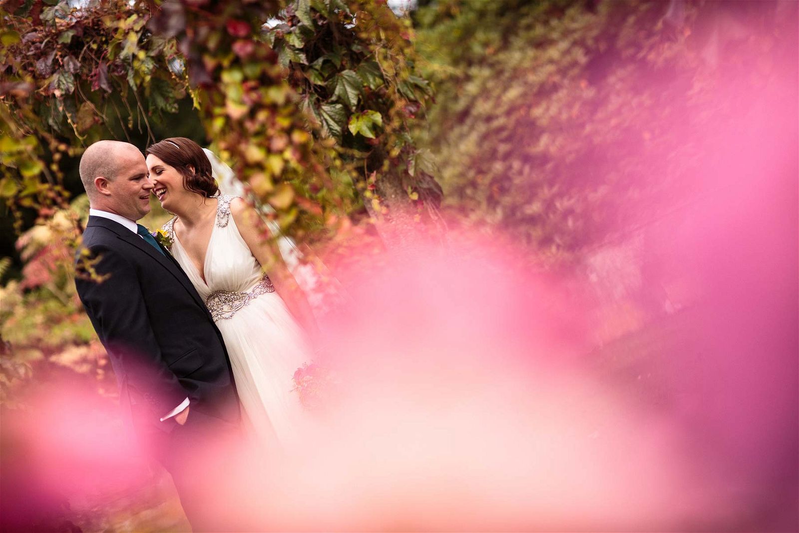 Creative relaxed couple portraits around the wonderful garden of Sandon Hall in Stafford by Stafford Reportage Wedding Photographer Stuart James