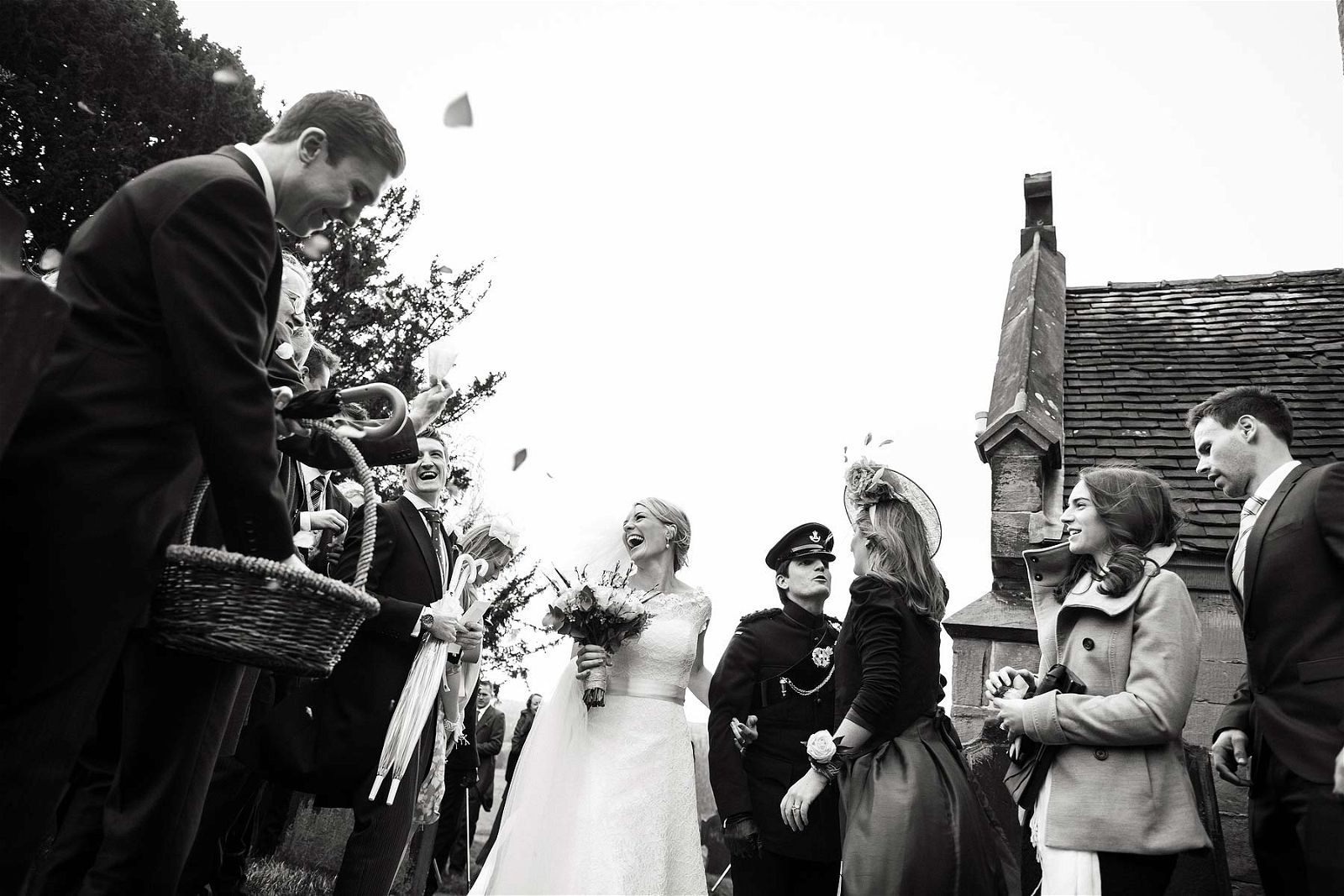 Fabulous guard of honour exit from the church at All Saints Church in Sandon by Staffordshire Documentary Wedding Photographer Stuart James