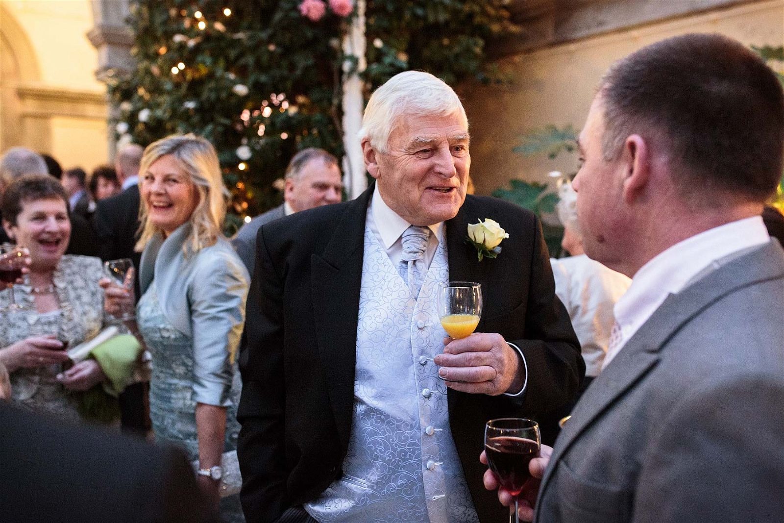 Reportage photographs as the guests enjoy the drinks reception at Sandon Hall in Stafford by Documentary Wedding Photographer Stuart James
