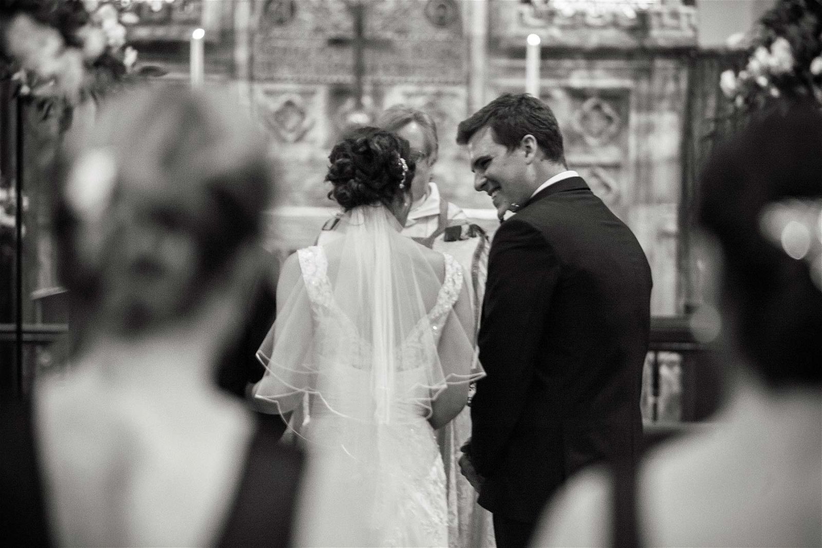Reportage photographs capture the emotion on the grooms face as his bride walks down the aisle at St Chads Church in Pattingham by Pattingham Wedding Photographer Stuart James