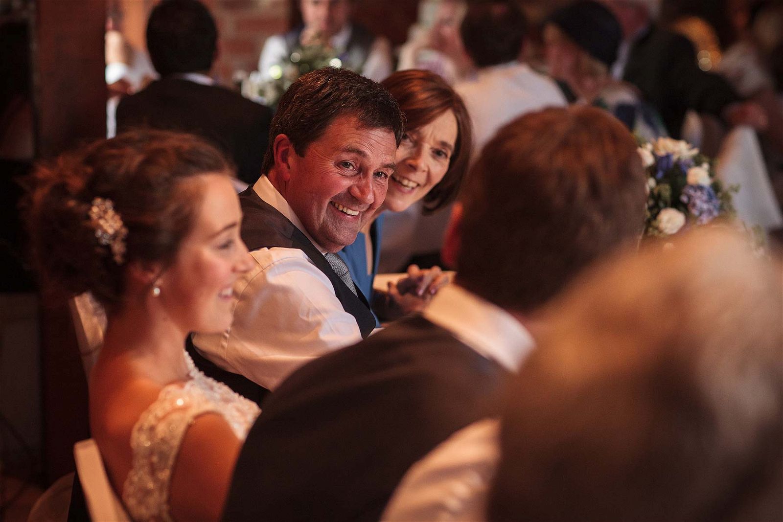 Candid photos that show the fun, emotion and excitement of the wedding breakfast and the fabulous speeches in the barn at Hundred House Hotel in Norton by Shropshire Reportage Wedding Photographer Stuart James