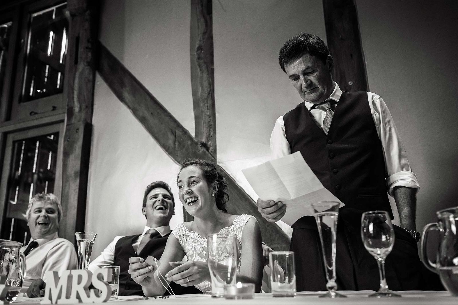 Candid photos that show the fun, emotion and excitement of the wedding breakfast and the fabulous speeches in the barn at Hundred House Hotel in Norton by Shropshire Reportage Wedding Photographer Stuart James