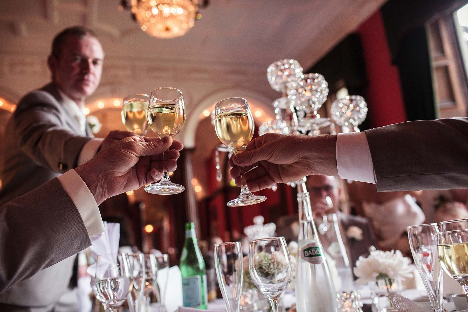 Raising a glass to Bride and Groom at Sandon Hall in Staffordshire by Professional Wedding Photographer Stuart James