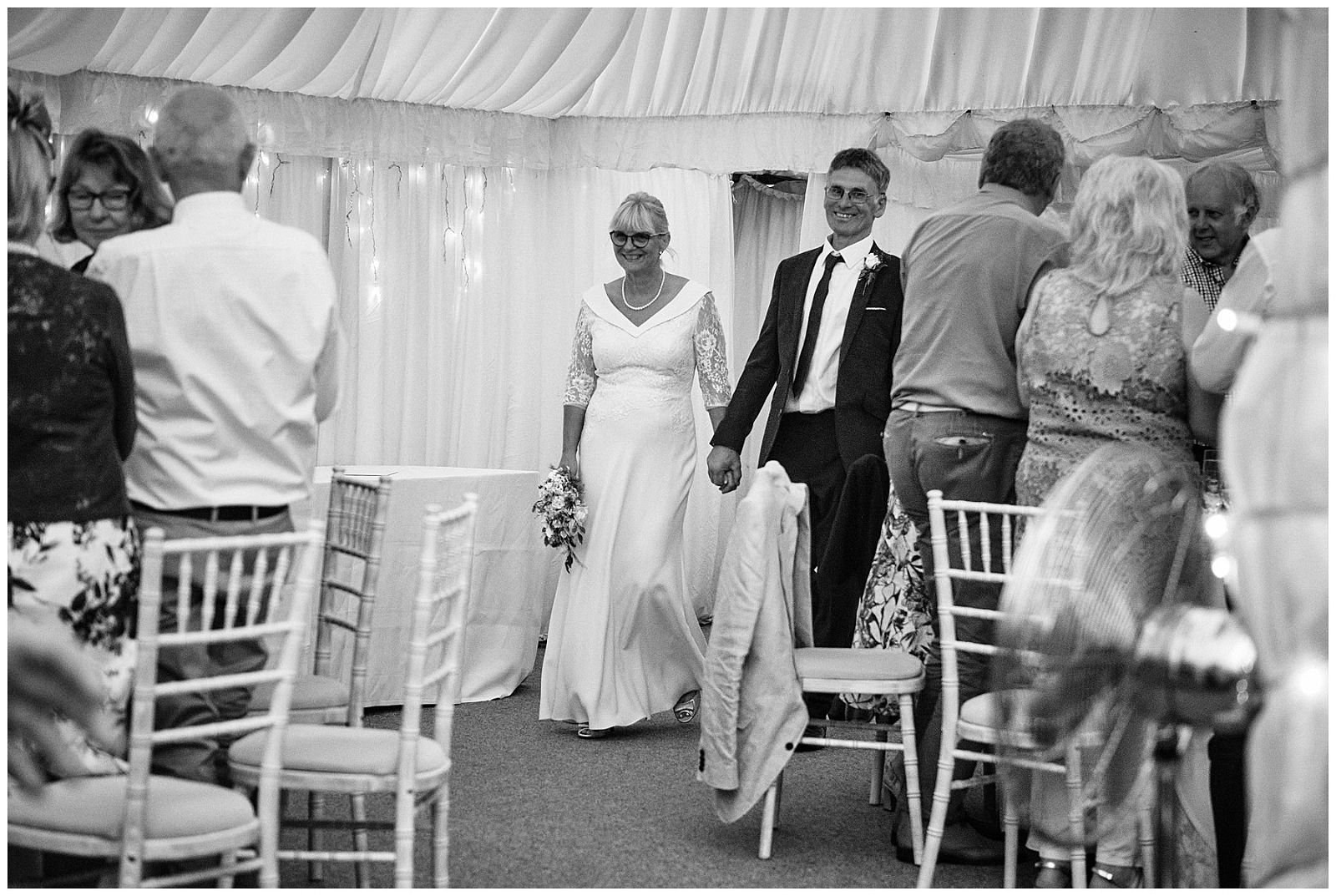 Photographs of the bride and grooms entrance to their wedding breakfast at Goldstone Hall in Shropshire by Documentary Wedding Photographer Stuart James