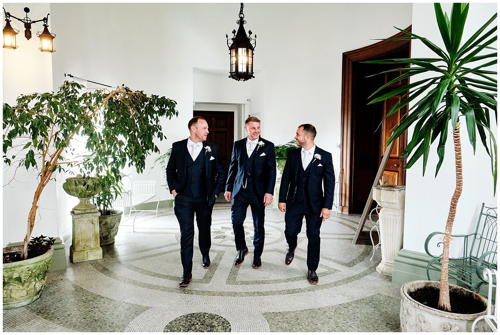 Entering in style, our groomsmen looking fabulous in their suits from Blooms Menswear, Wolverhampton at Hawkstone Hall in Shrewsbury by Documentary Wedding Photographer Stuart James