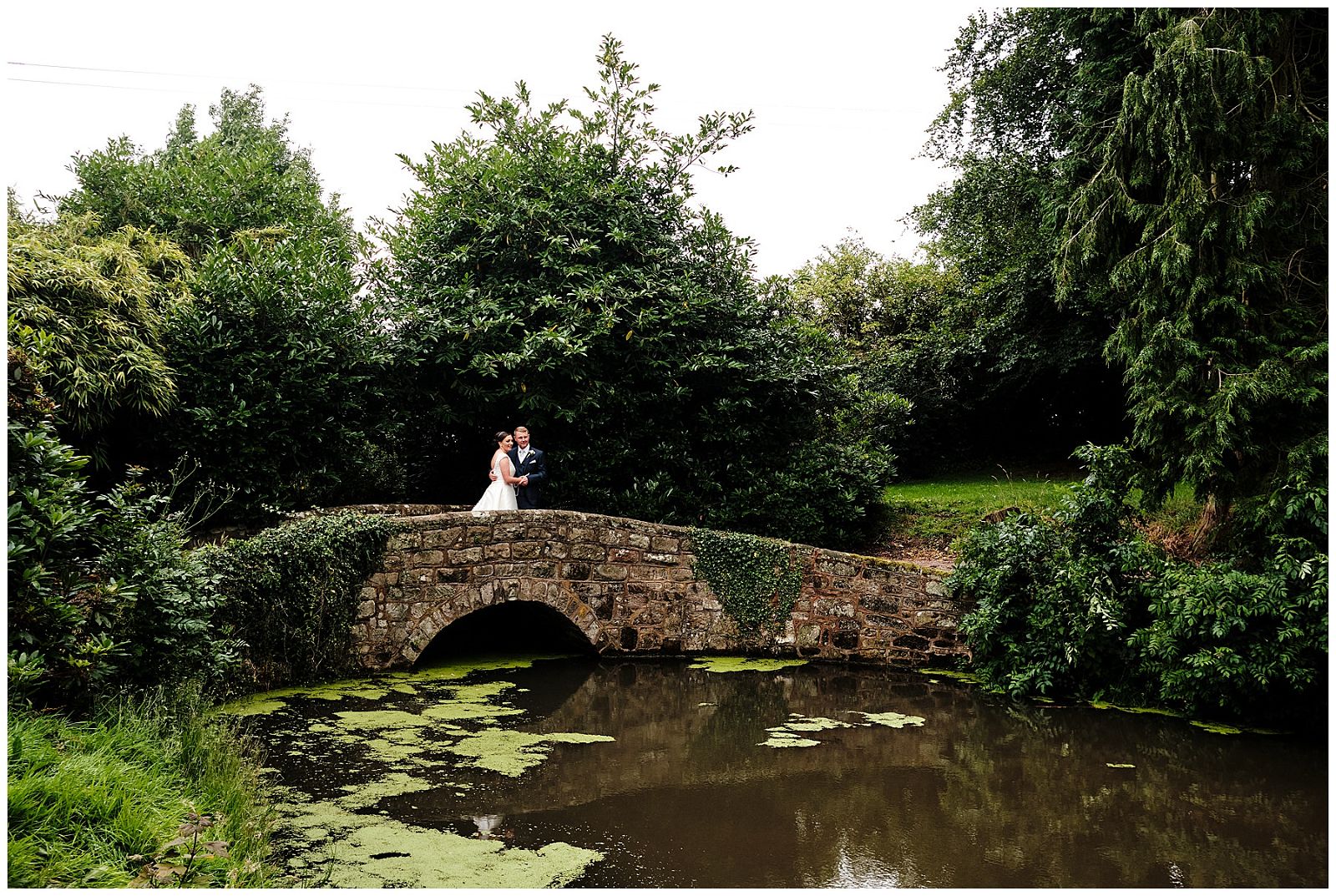 Utilising the bridge over the stream at Hawkstone Hall in Shrewsbury by Documentary Wedding Photographer Stuart James