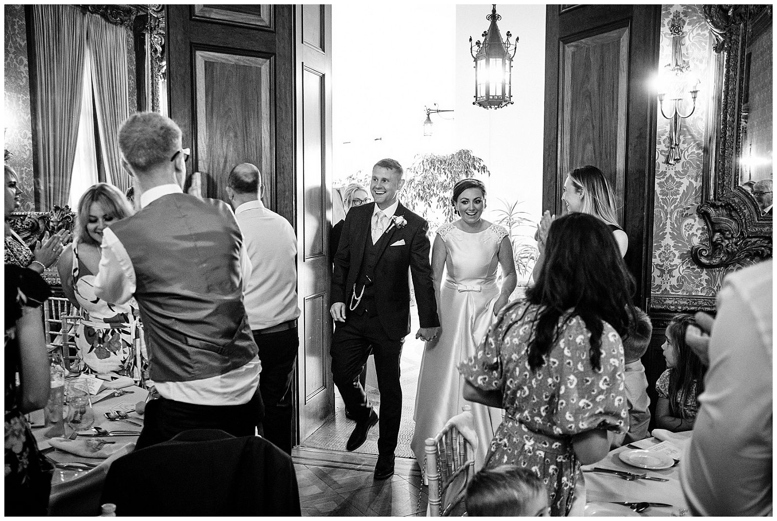 Wonderful moment to capture with the entrance of the Bride and Groom to the wedding breakfast at Hawkstone Hall in Shrewsbury by Documentary Wedding Photographer Stuart James